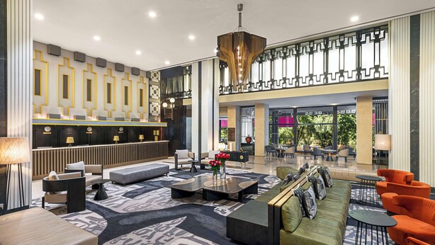 A spacious lobby with a reception desk, seating areas, and a decorative ceiling light. - Hilton Addis Ababa (Addis Ababa)