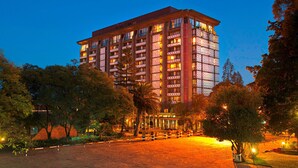 A multi-story hotel with a modern architectural design, featuring balconies on each floor and a well-lit entrance area. - Hilton Addis Ababa (Addis Ababa)