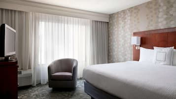 Premium bedding, desk, laptop workspace, blackout drapes