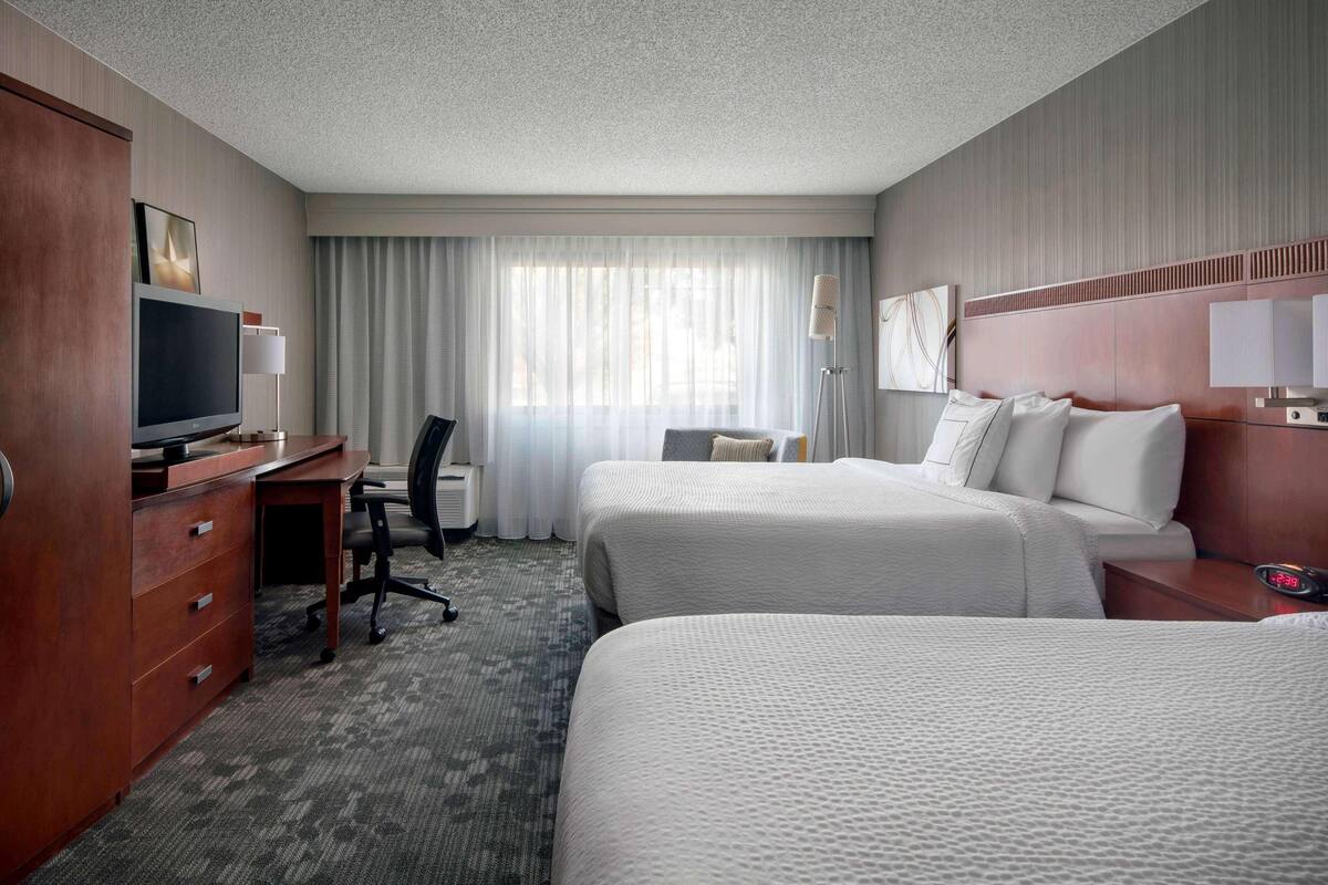 Premium bedding, desk, laptop workspace, blackout curtains