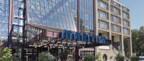 A modern building with a large glass facade and the name "MARITIM" prominently displayed.