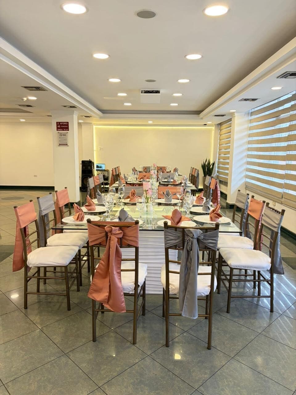 A conference room with a long table, chairs, and a speaker system.
