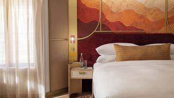 A hotel room with a bed, a nightstand, a lamp, and a wall with a textured design.