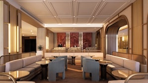 A hotel lobby with seating areas, a reception desk, and a decorative wall. - Amora Hotel Adelaide (Adelaide)