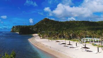 On the beach, white sand, free beach cabanas, beach umbrellas