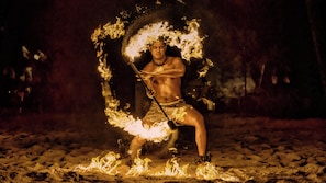 A person performing with fire in a circular formation.