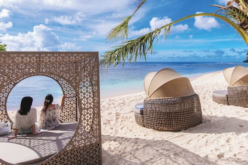 On the beach, white sand, free beach cabanas, beach umbrellas