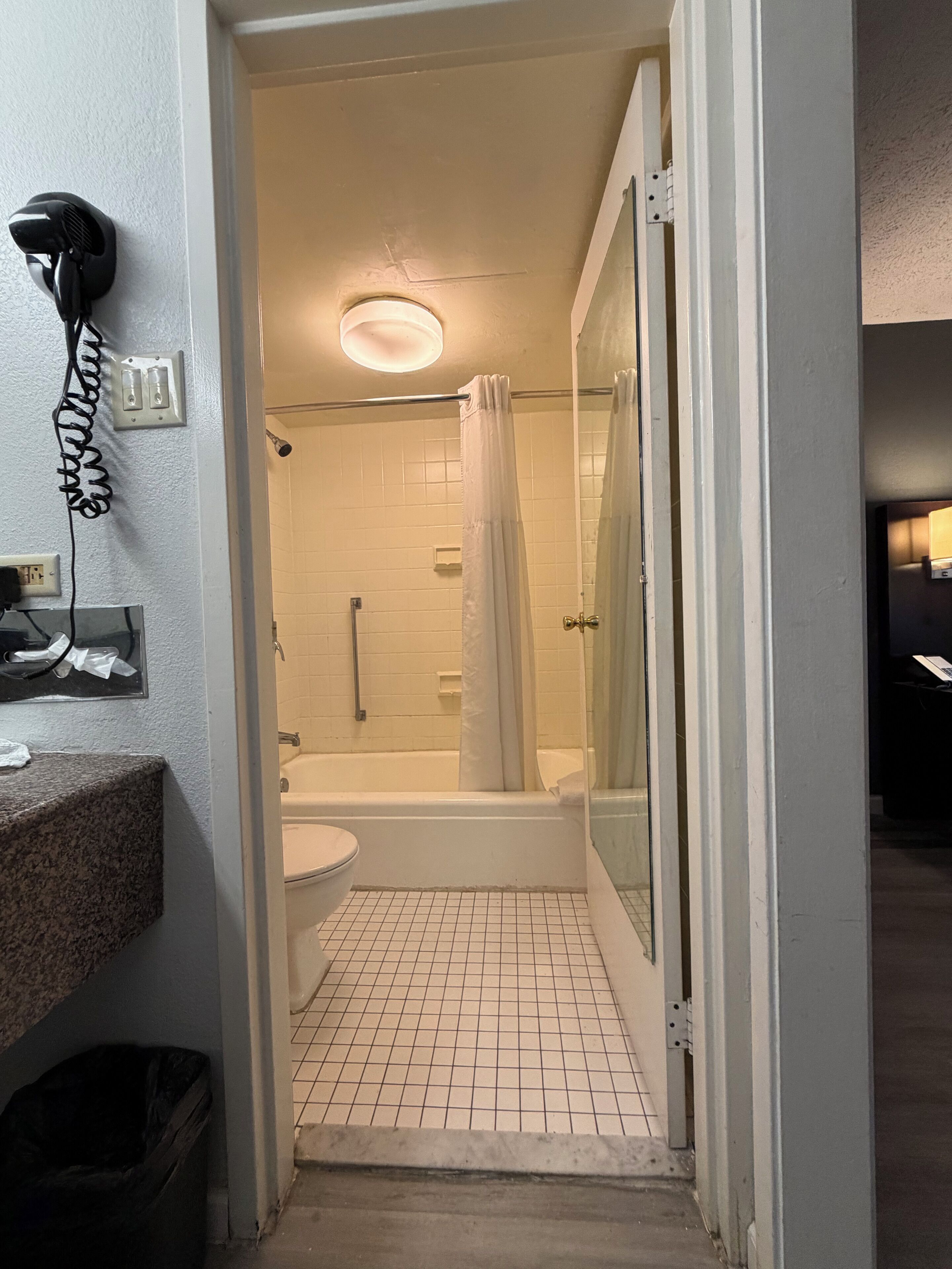 Une salle de bain avec douche, toilettes et lavabo.
