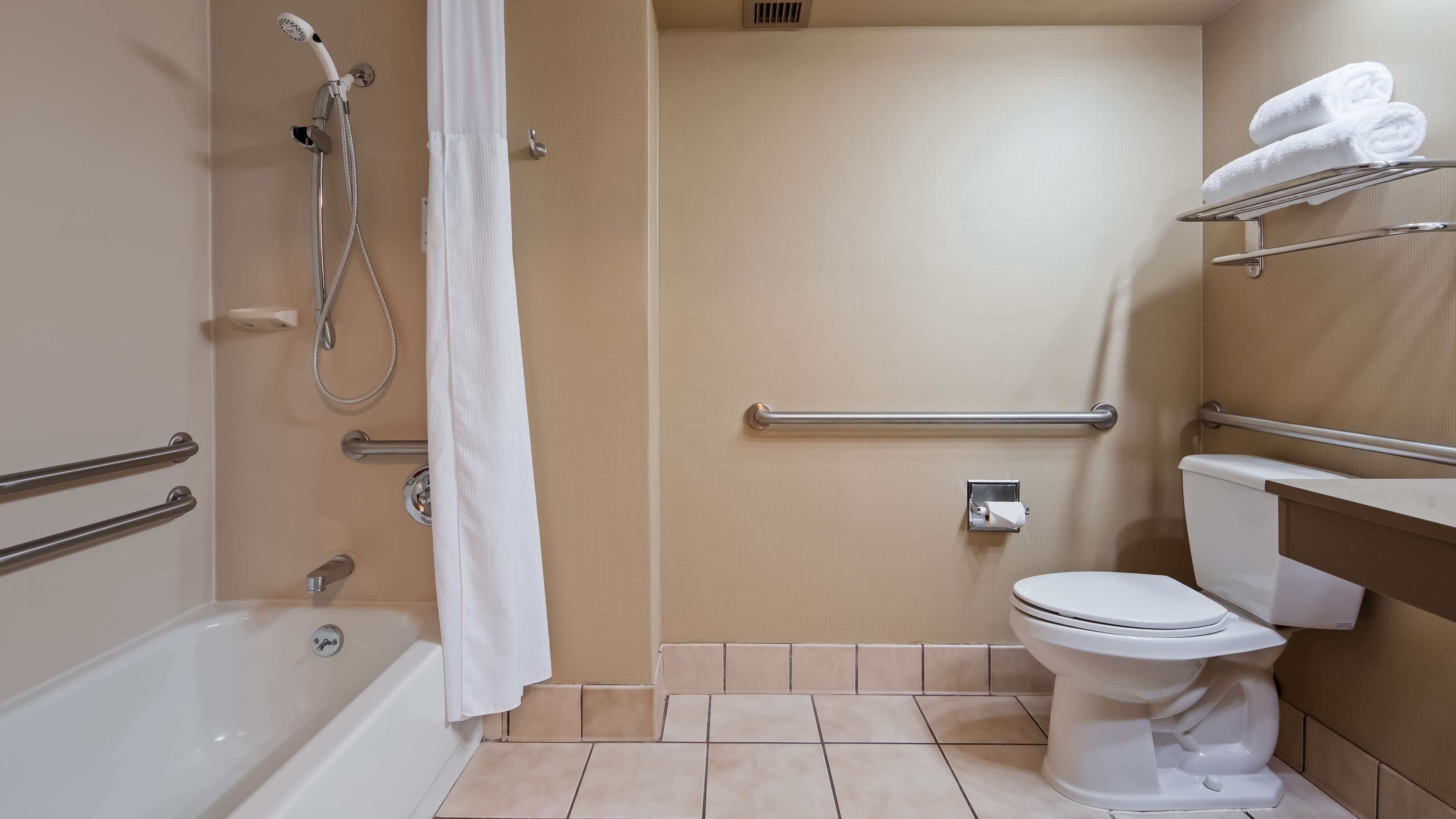 combined shower/bathtub, spring water bathtub, hair dryer, towels