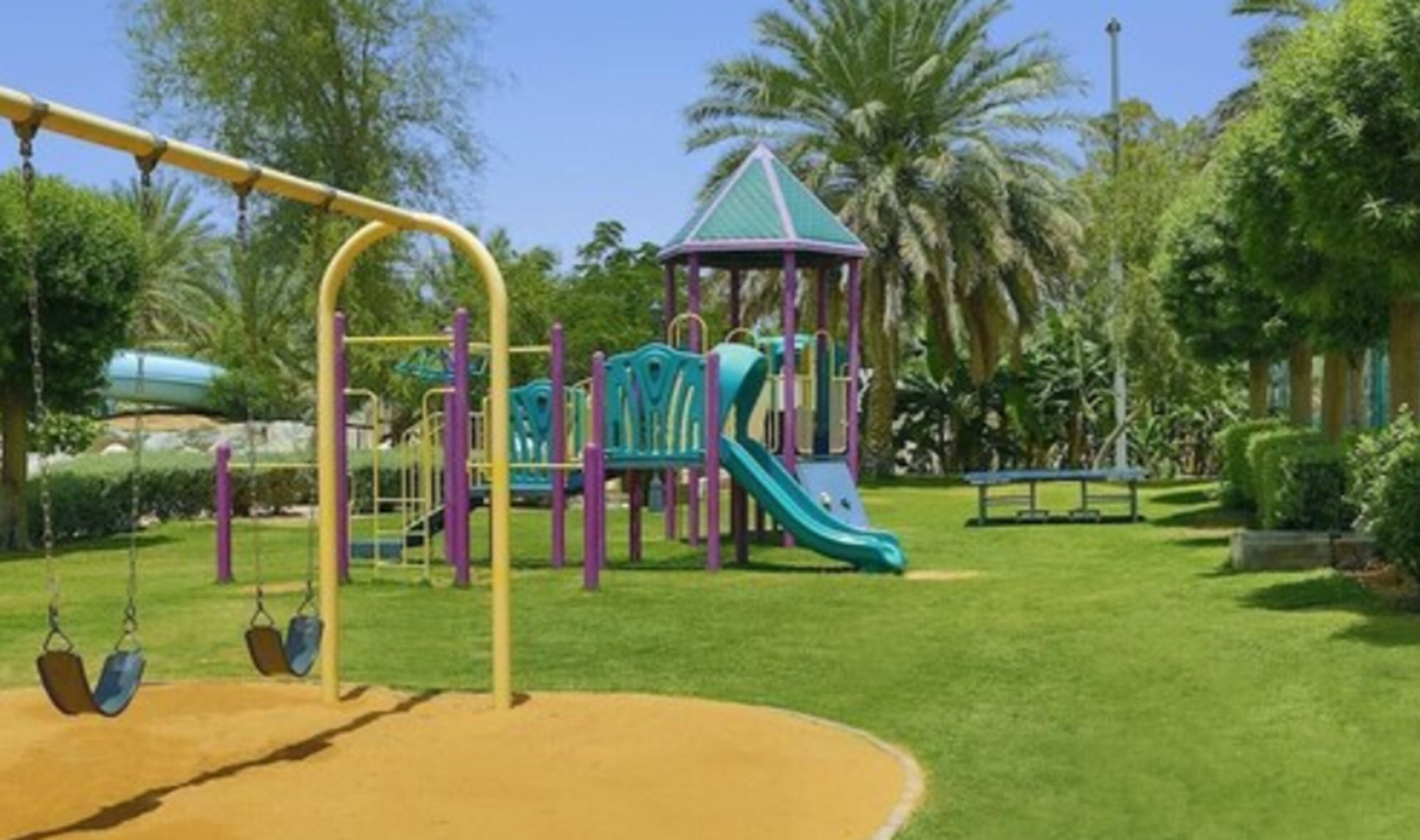 A playground with swings, slides, and a climbing structure.