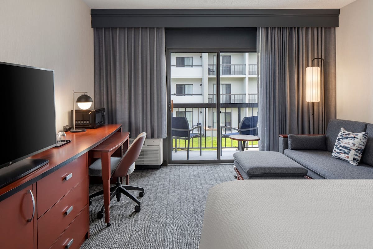 Premium bedding, desk, laptop workspace, blackout drapes