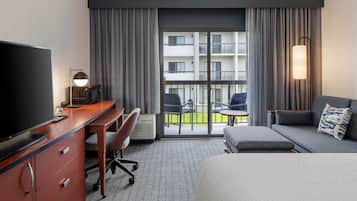 Premium bedding, desk, laptop workspace, blackout drapes