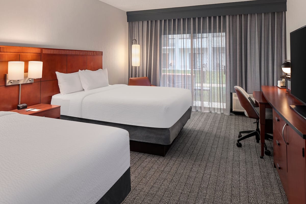Premium bedding, desk, laptop workspace, blackout drapes