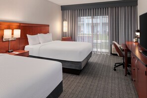 Premium bedding, desk, laptop workspace, blackout drapes