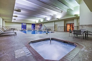 Una piscina techada, sillones reclinables de piscina