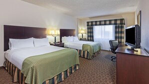 A hotel room with two beds, a desk with a television, and a chair. - Holiday Inn Springdale/Fayetteville Area by IHG (Springdale)