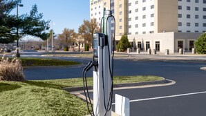 A parking area with a charging station in front of a hotel. - Holiday Inn Springdale/Fayetteville Area by IHG (Springdale)
