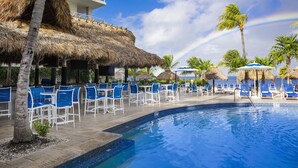 A poolside area with blue chairs and a thatched-roof structure. - Reefhouse Resort & Marina (Key Largo)