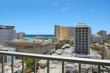 In-room safe, desk, blackout drapes, iron/ironing board at Waikiki Malia