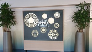 A wall with a large sign for Mercure Hotels, surrounded by decorative circular patterns. - Mercure Nottingham Sherwood Hotel (Nottingham)