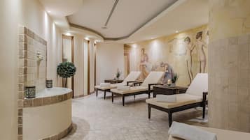 Relax in a serene spa area with a large hot tub, lounge chairs, and a soothing mural.