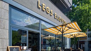 A restaurant named 'Legs Eleven' with outdoor seating and a chalkboard sign. - Hotel Mondial am Dom Cologne - MGallery (Cologne)