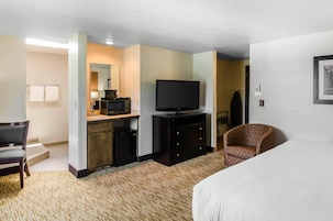 Premium bedding, desk, laptop workspace, blackout drapes