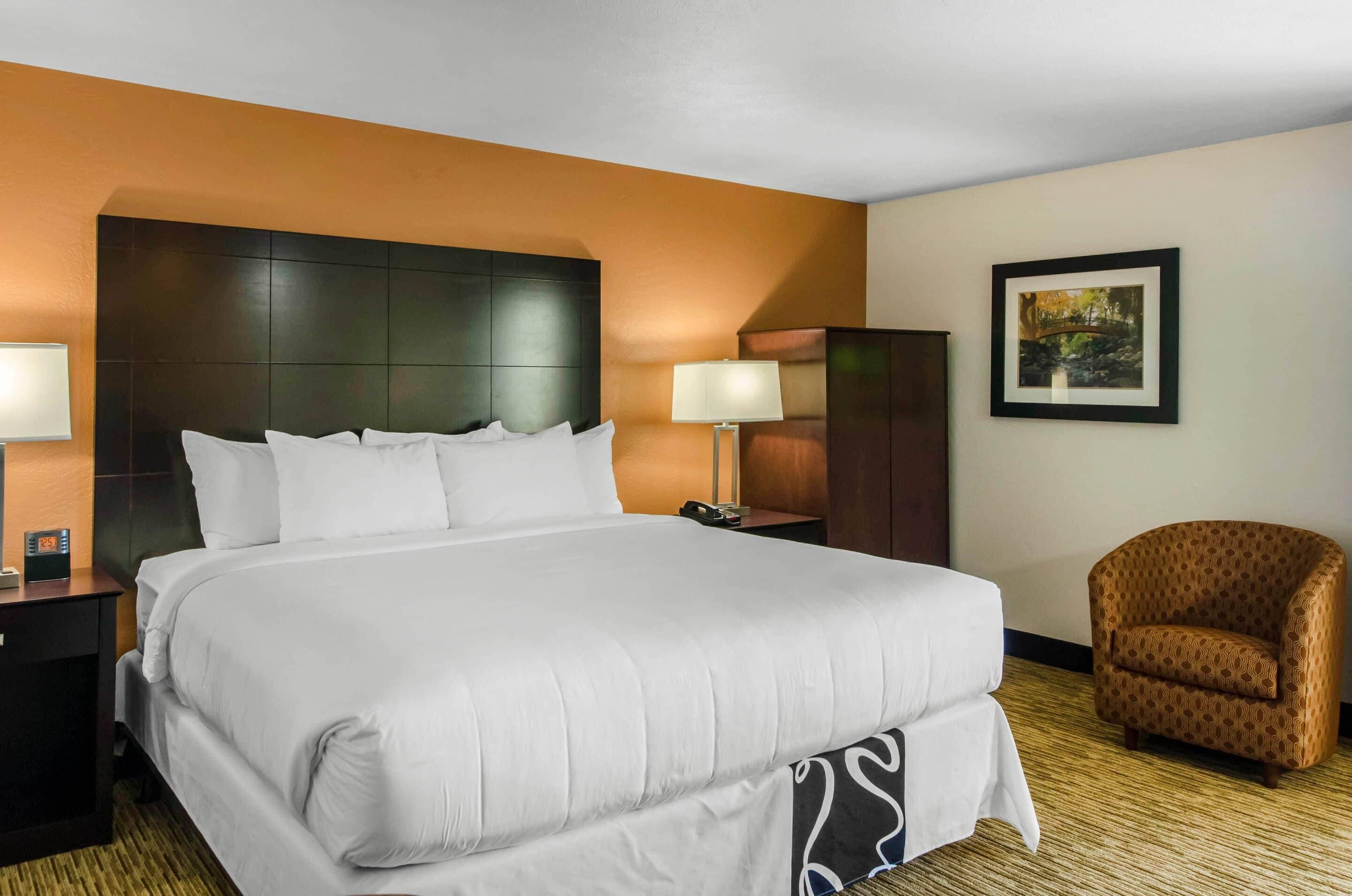 Premium bedding, desk, laptop workspace, blackout drapes