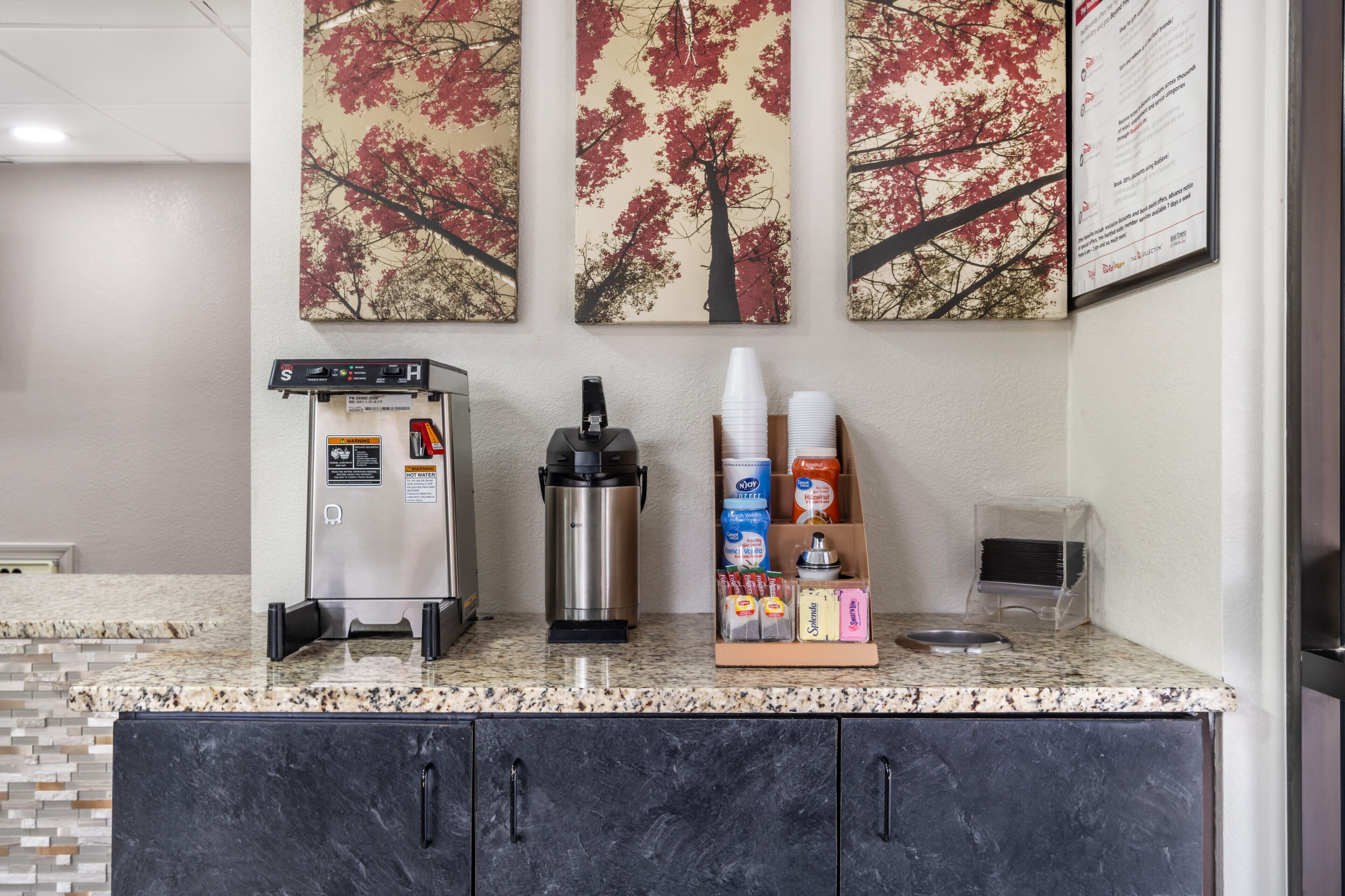 A kitchenette with a coffee machine, a water dispenser, and a coffee cup holder.
