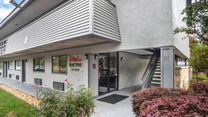 A building with a sign for 'Red Roof Inn' and 'HomeTown Studios'. - Red Roof Inn Greenville (Greenville)