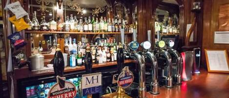A bar with multiple taps, including one labeled "Woodford's WHERRY ALE."