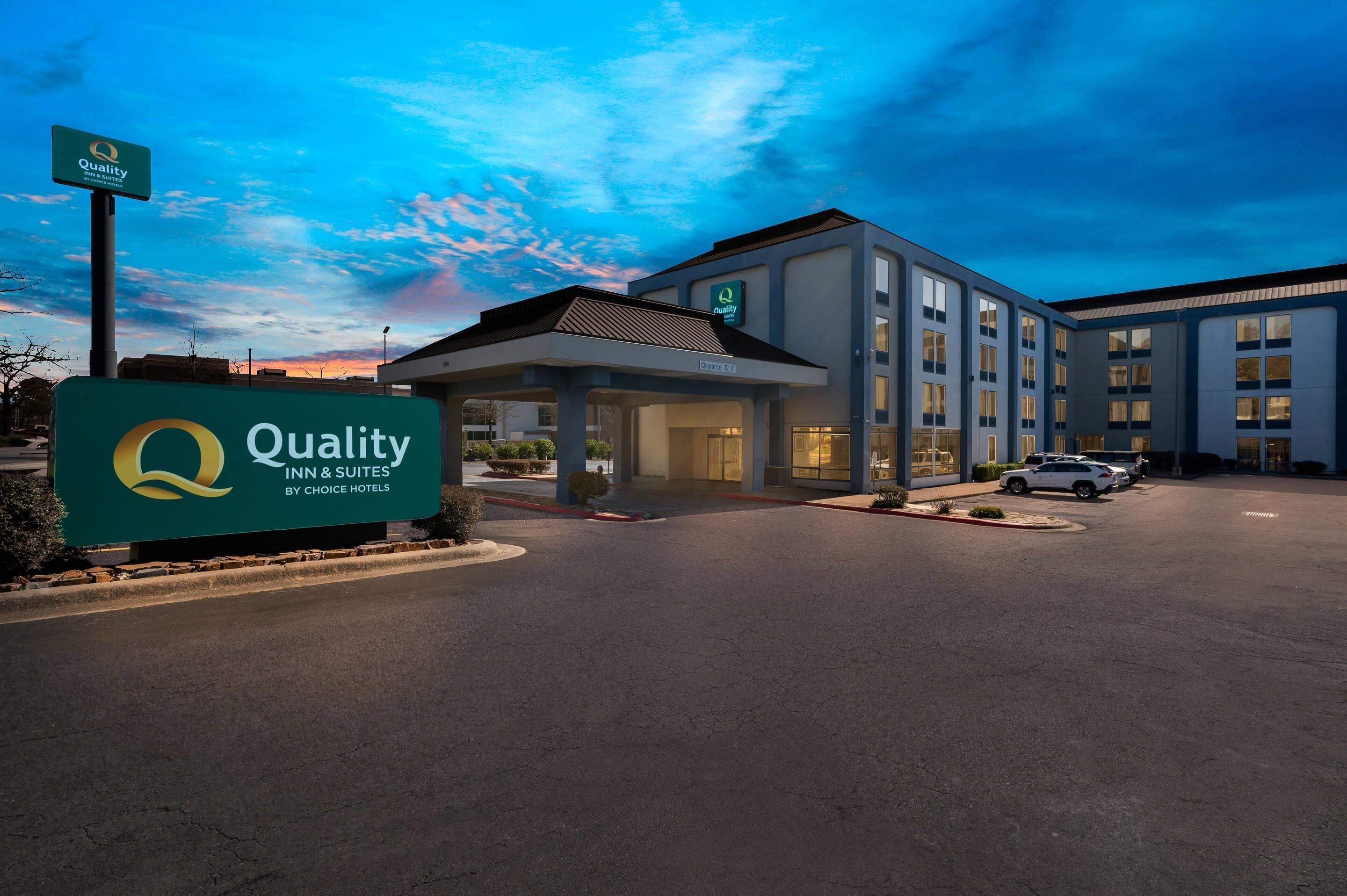 A hotel with a clear sign indicating it is a Quality Inn & Suites by Choice Hotels.