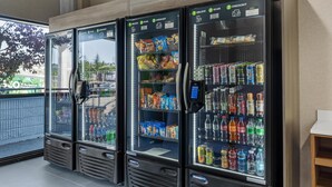 Three self-service beverage vending machines with various drink options and snacks. - Best Western Plus Downtown Tacoma (Tacoma)