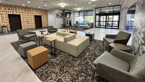 A spacious lobby with seating areas, a patterned wall, and large windows. - Best Western Plus Downtown Tacoma (Tacoma)