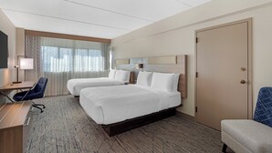 A hotel room with two beds, a desk, a chair, a TV, and a wardrobe. - Best Western Plus Downtown Tacoma (Tacoma)