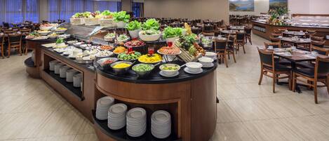 A buffet area with various food items and a counter.
