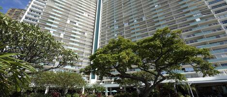 A high-rise hotel with multiple balconies and a central vertical feature.