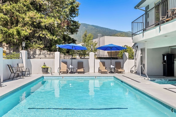 Seasonal outdoor pool, open 9:00 AM to 10:00 PM, pool umbrellas