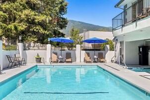 Seasonal outdoor pool, open 9:00 AM to 10:00 PM, pool umbrellas