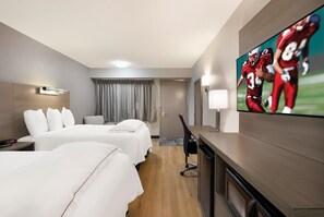 A hotel room with two beds, a TV on the wall, a desk, and a chair. - Red Roof Inn PLUS+ Chicago - Naperville (Naperville)