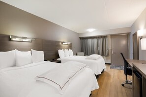 A hotel room with two beds, a desk, and a chair. - Red Roof Inn PLUS+ Chicago - Naperville (Naperville)
