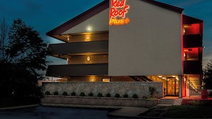 A multi-story building with a prominent Red Roof Plus sign. - Red Roof Inn PLUS+ Chicago - Naperville (Naperville)