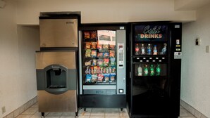 A vending machine with snacks and a push button for dispensing items. - Red Roof Inn PLUS+ Chicago - Naperville (Naperville)