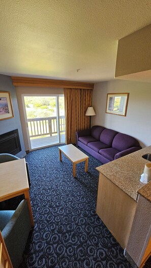 Room, 1 King Bed, Partial Ocean View | Living area | 42-inch LCD TV with satellite channels, TV, fireplace