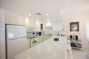 Full-size fridge, stovetop, dishwasher, cookware/dishes/utensils