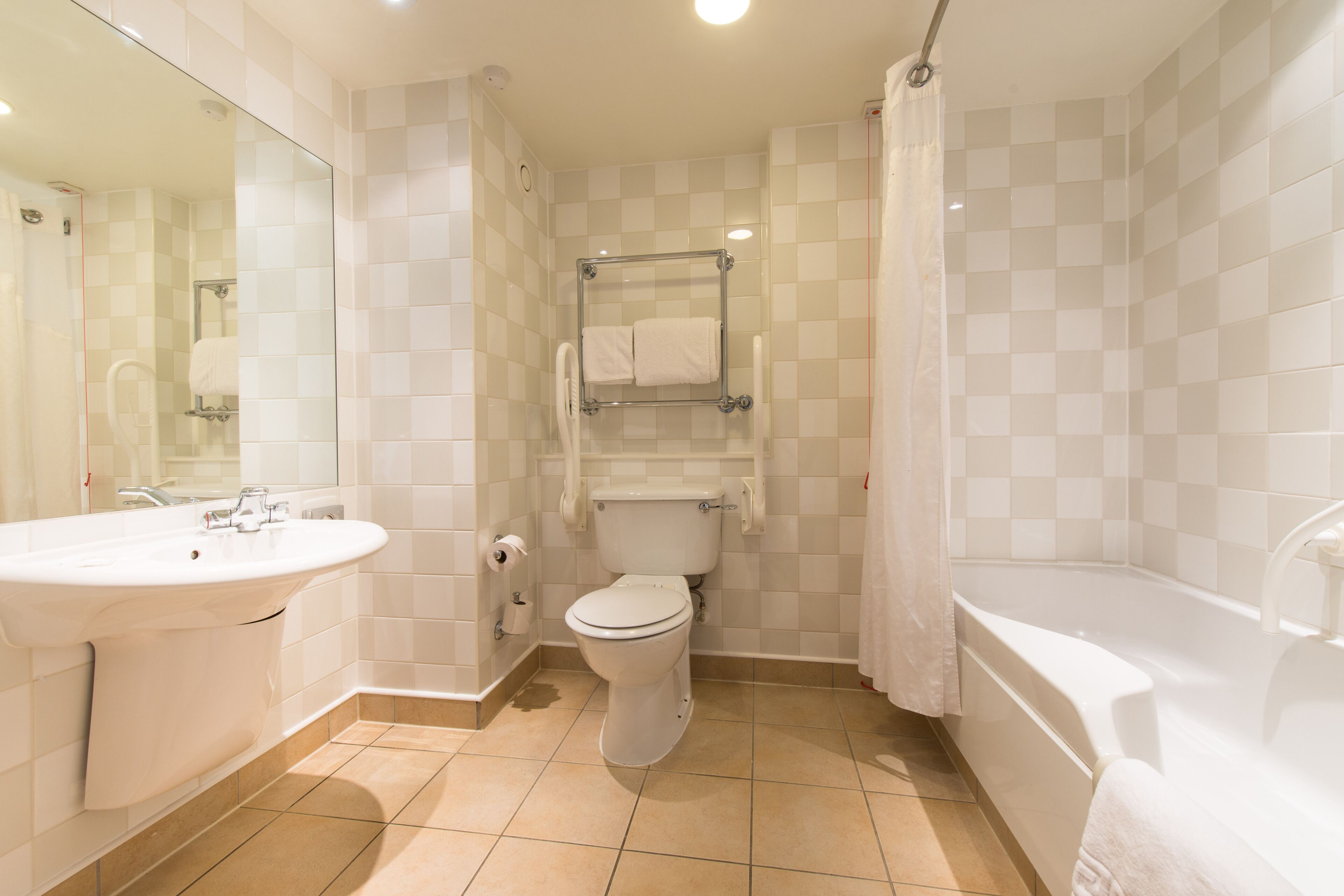 A bathroom with a sink, toilet, and bathtub.