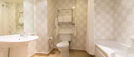 A bathroom with a sink, toilet, and bathtub.
