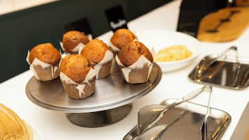 A tray of muffins on a stainless steel stand.