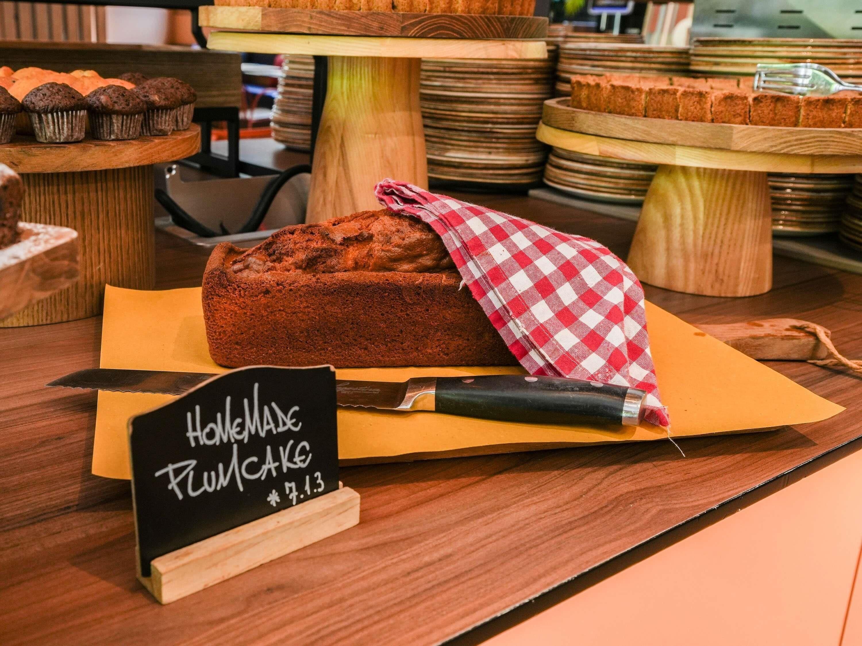 A bakery display with a loaf of pumpkin cake and a sign indicating it is homemade.