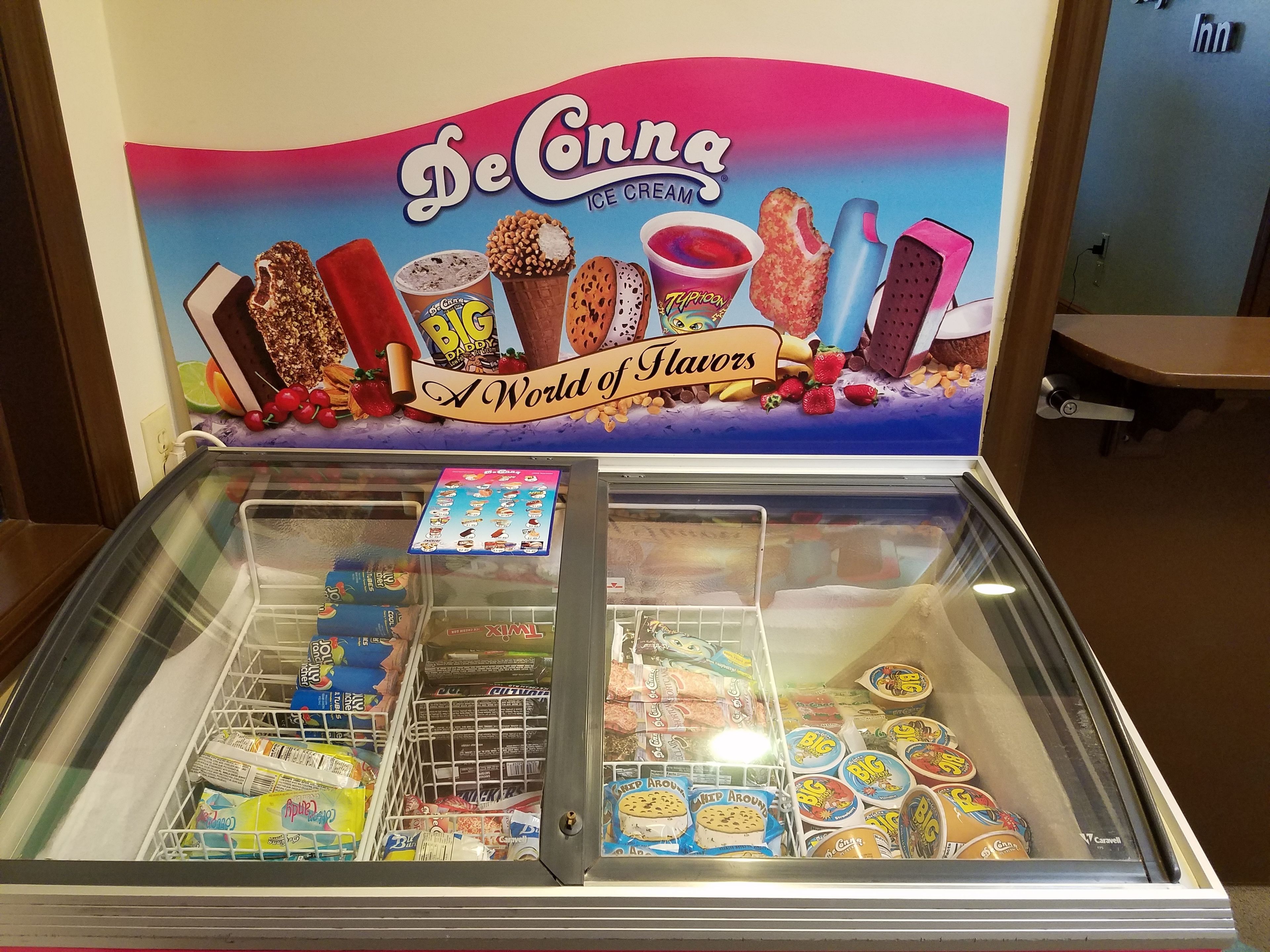 A De'Connia ice cream display with various flavors and toppings.